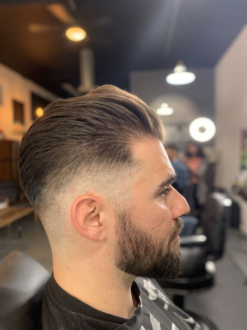 A pompadour fade with a full beard
