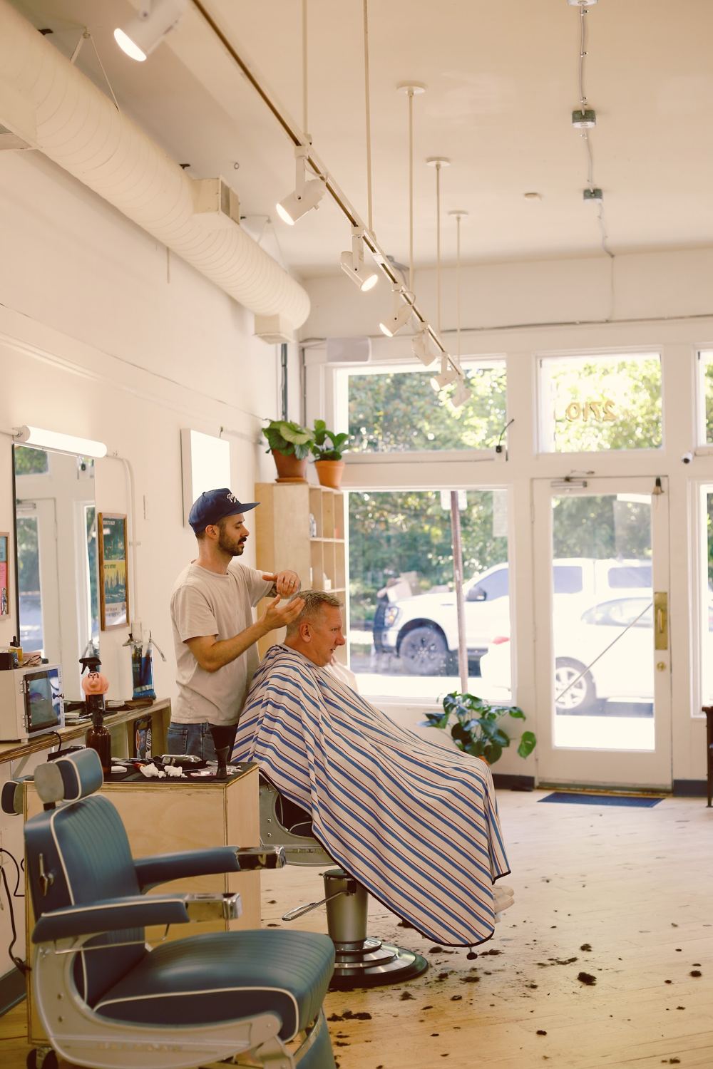 A cut by the front windows at Forestry Barbershop