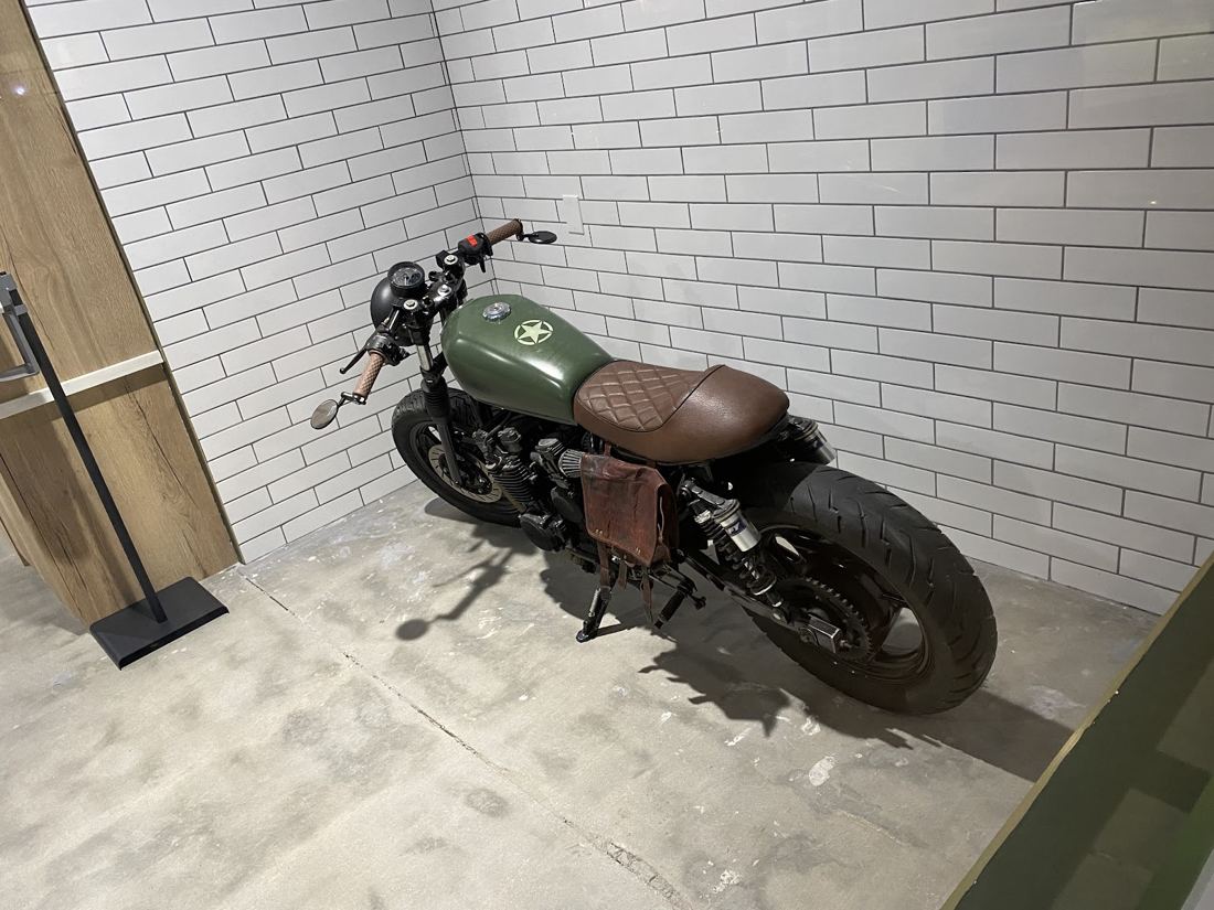The cafe racer parked inside the shop