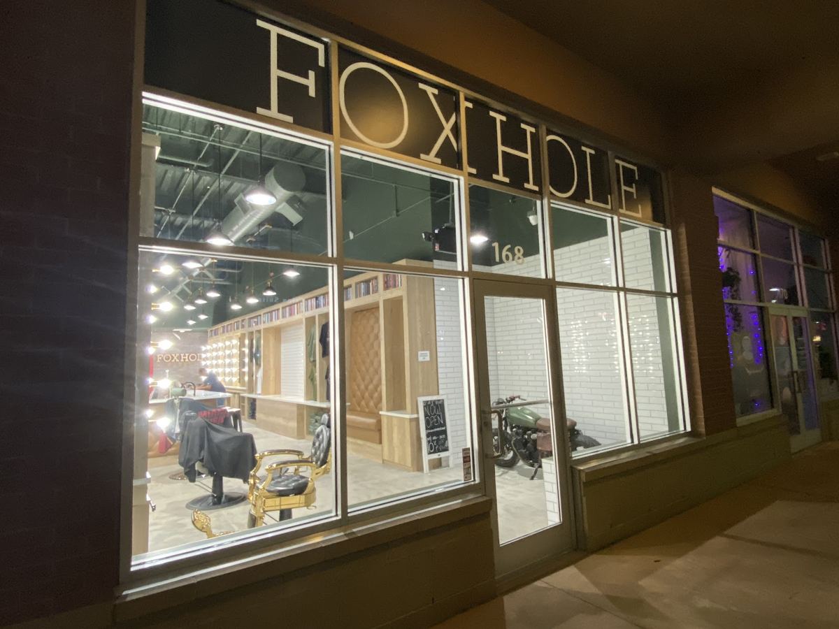 Foxhole Barbershop lit up at night