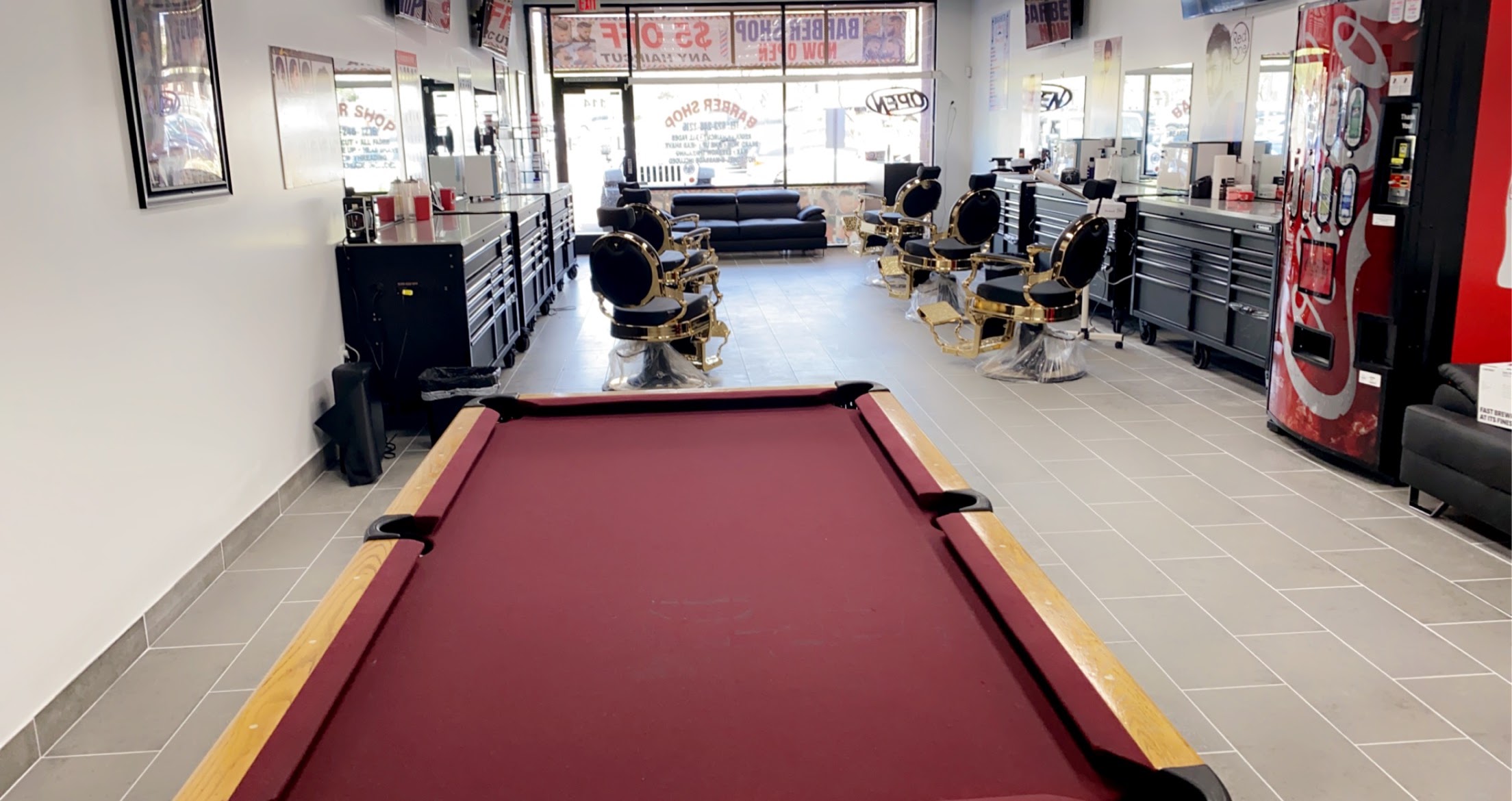 The Kingsman pool table with the gold chairs along the shop floor