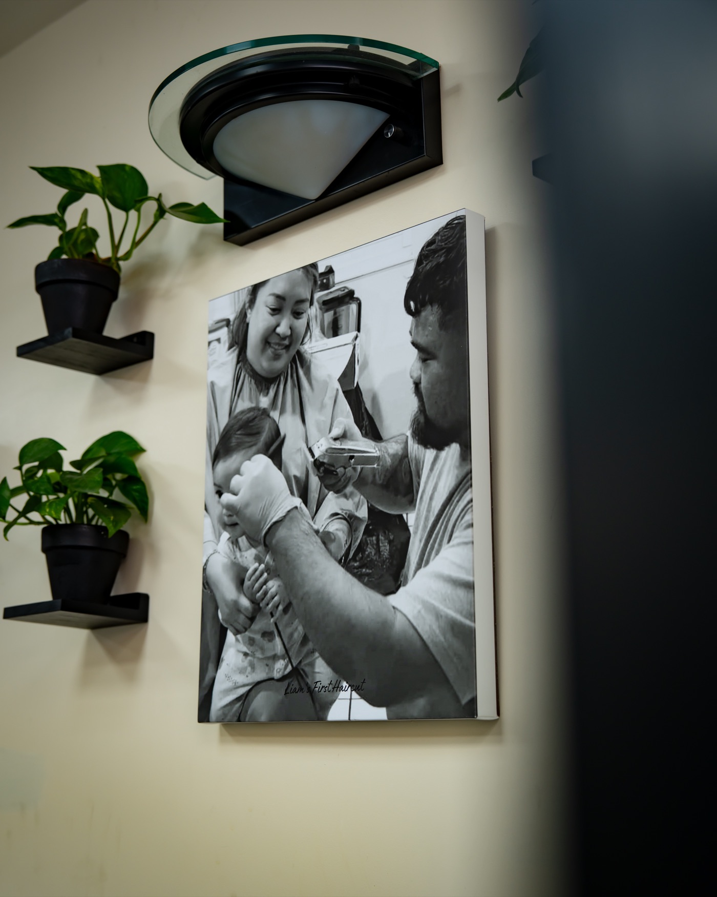 Framed family photo and plants on the shop wall at Lakay’s