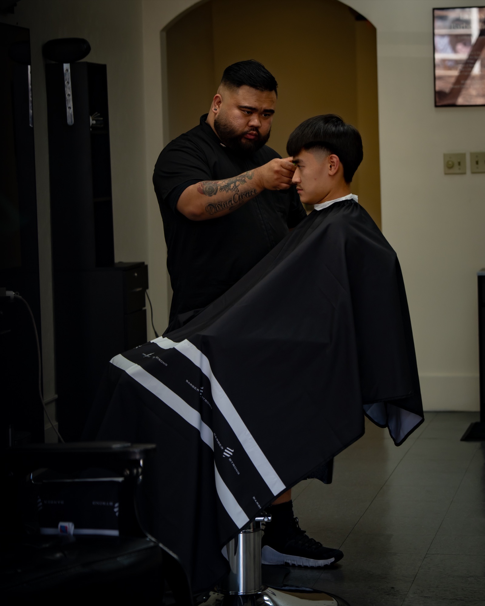 Mac working on a client’s cut at Lakay’s Barbershop