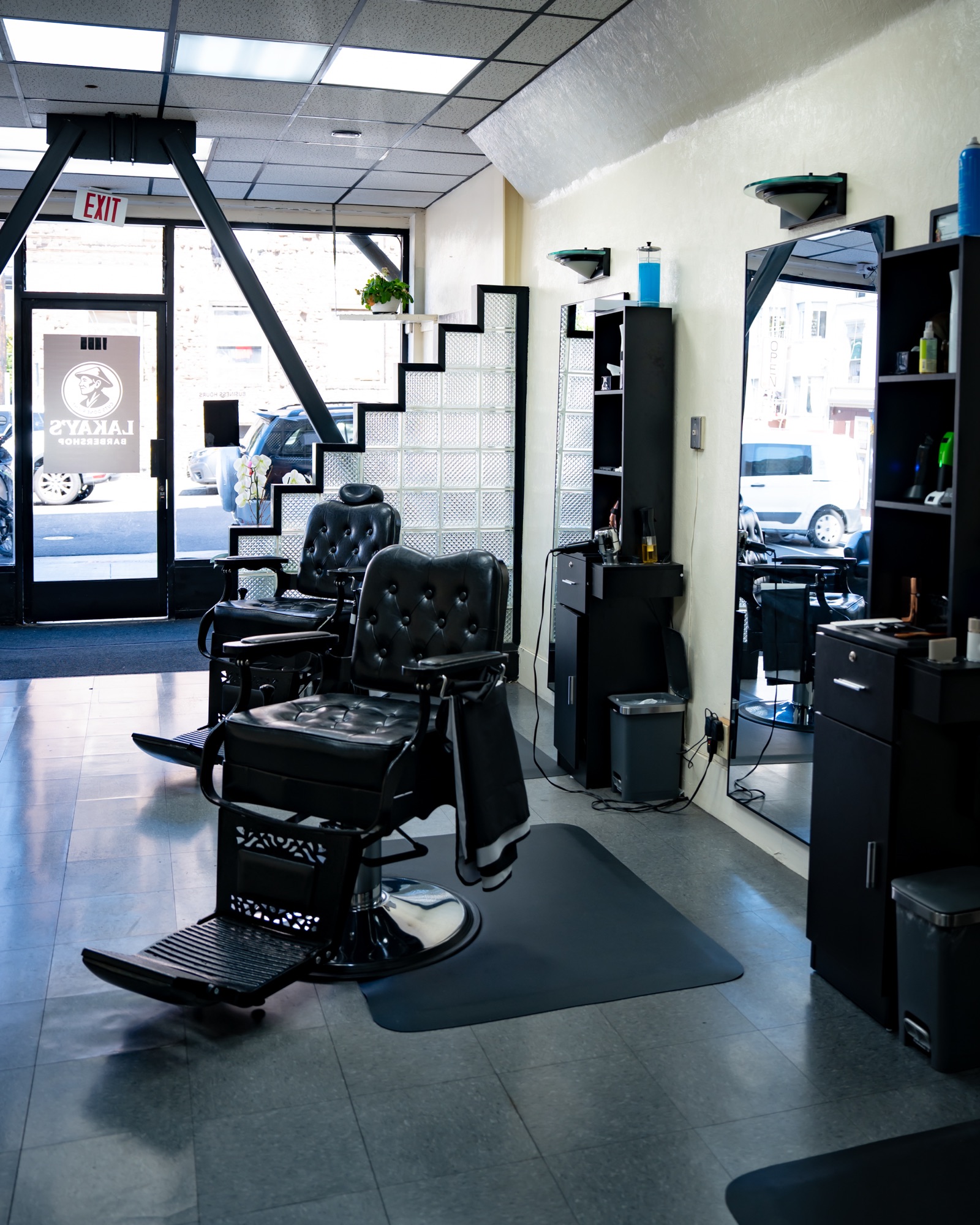 The shop floor at Lakay’s Barbershop with vintage tufted barber chairs