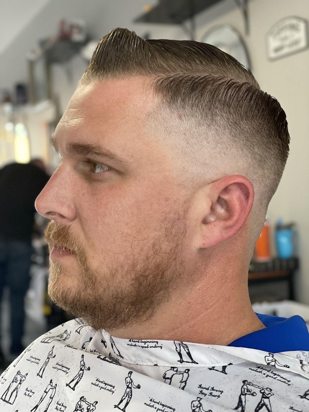 A sharp pomp fade cut at Mama Tried