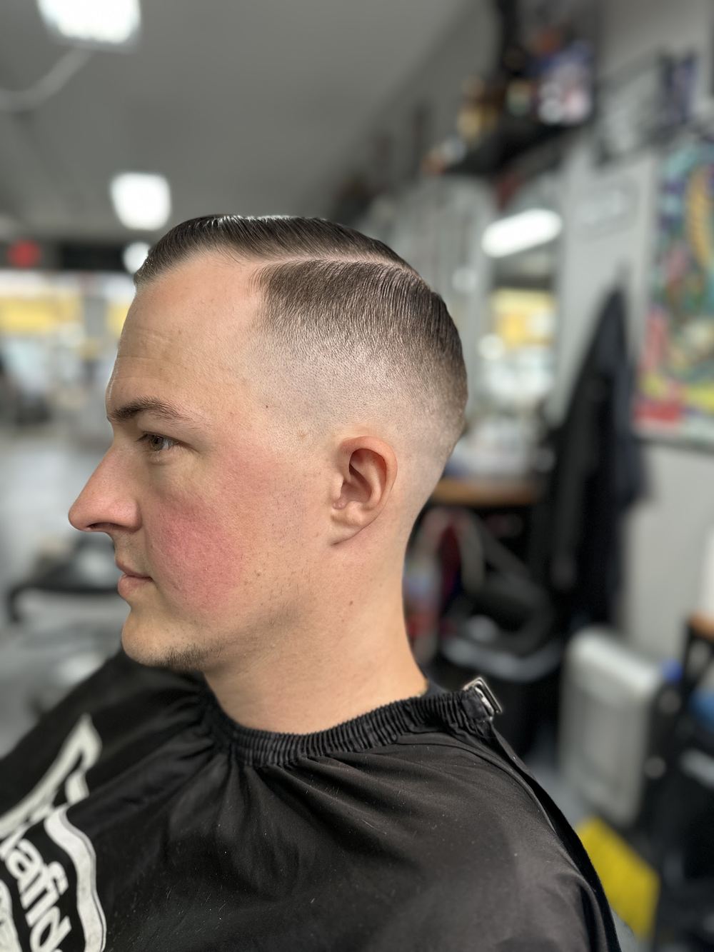 A clean side part with a skin fade