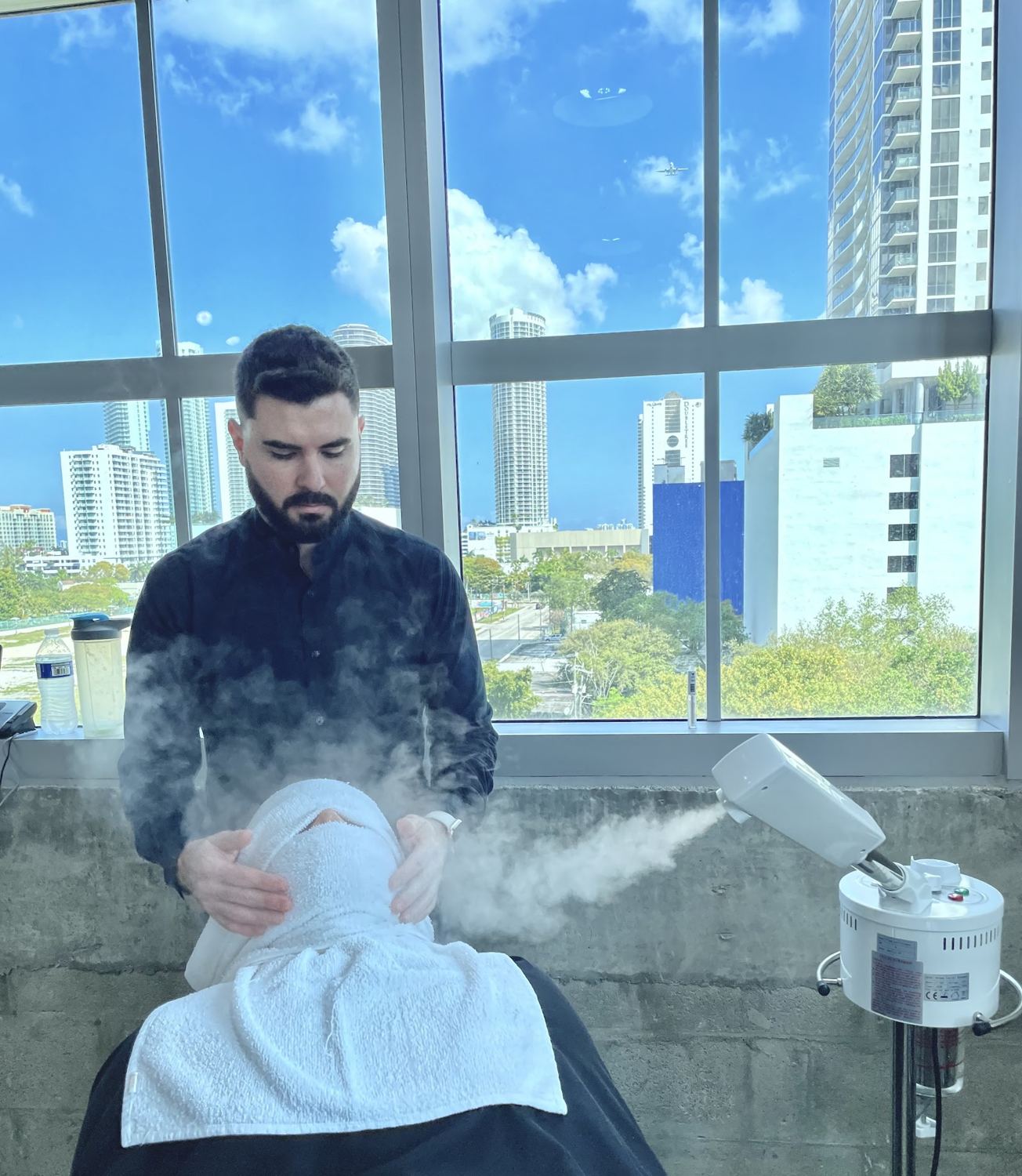 A hot towel treatment with the Miami skyline out the window