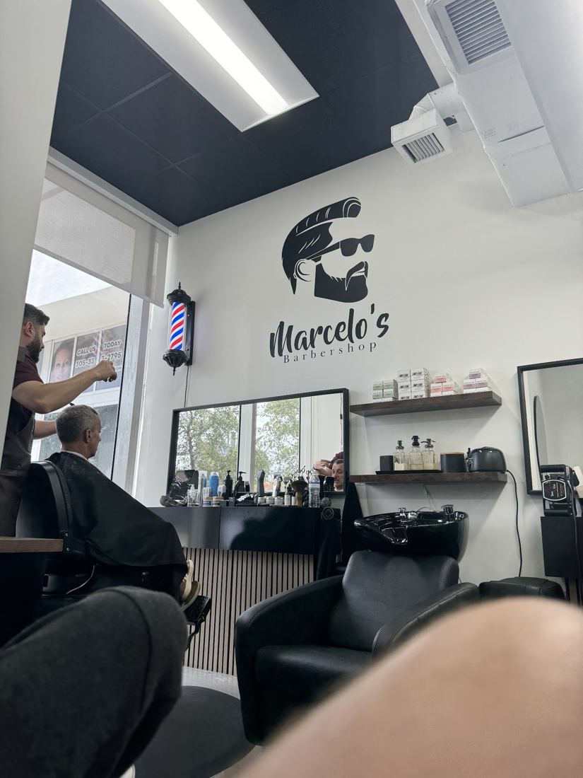 A cut in progress under the shop logo