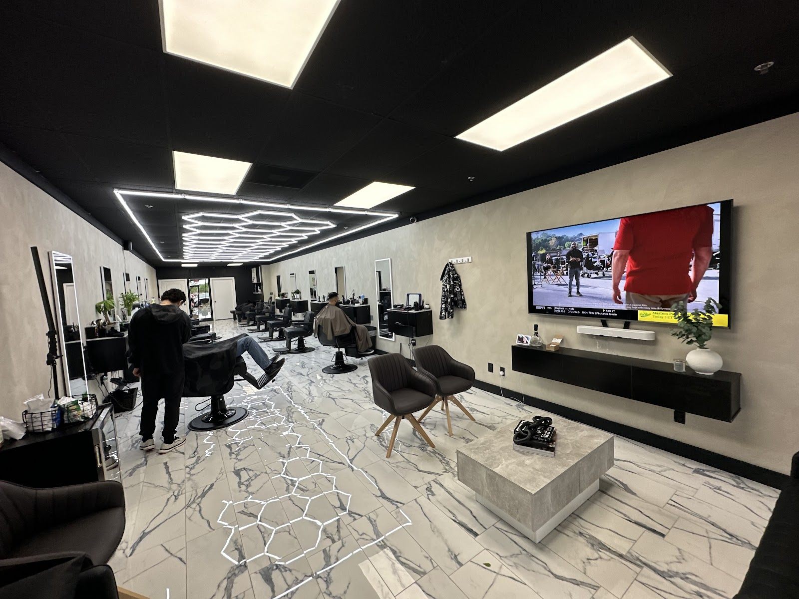 The marble floor and hex lights at R.O Barber Studio in Plano