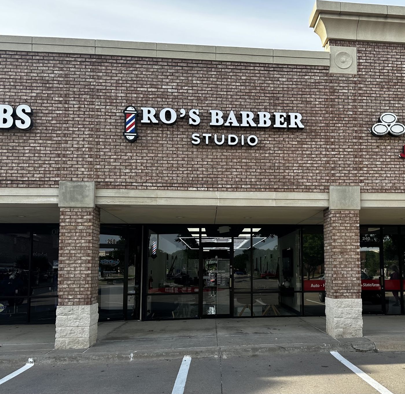 The Ro's Barber Studio storefront on Midway Rd