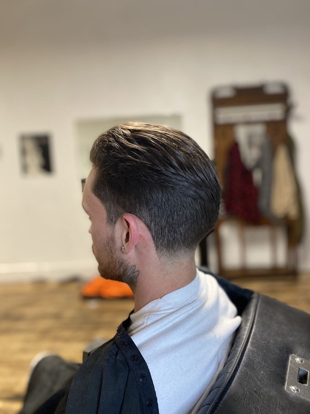 A slicked-back cut, side profile