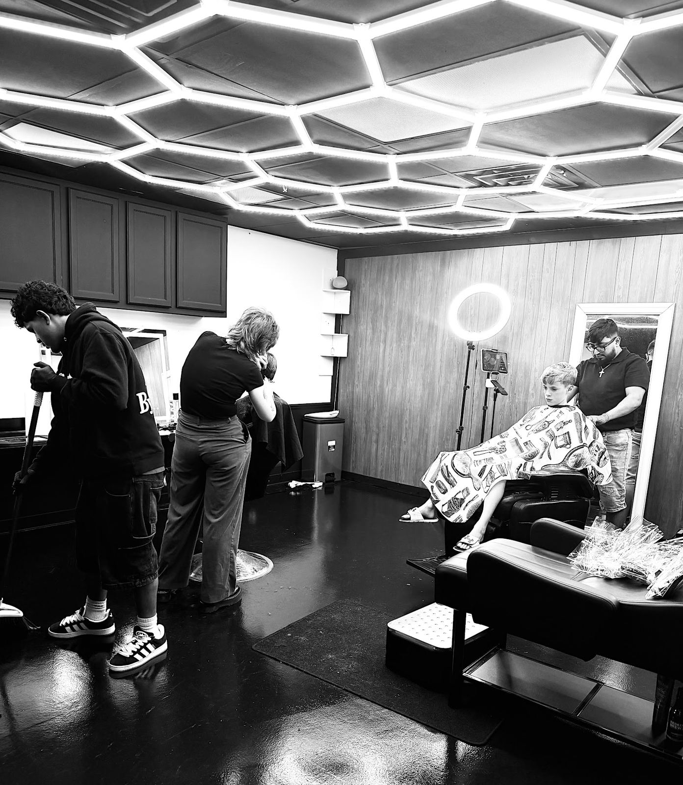 Inside Santos Barber Studio under the hex ceiling light