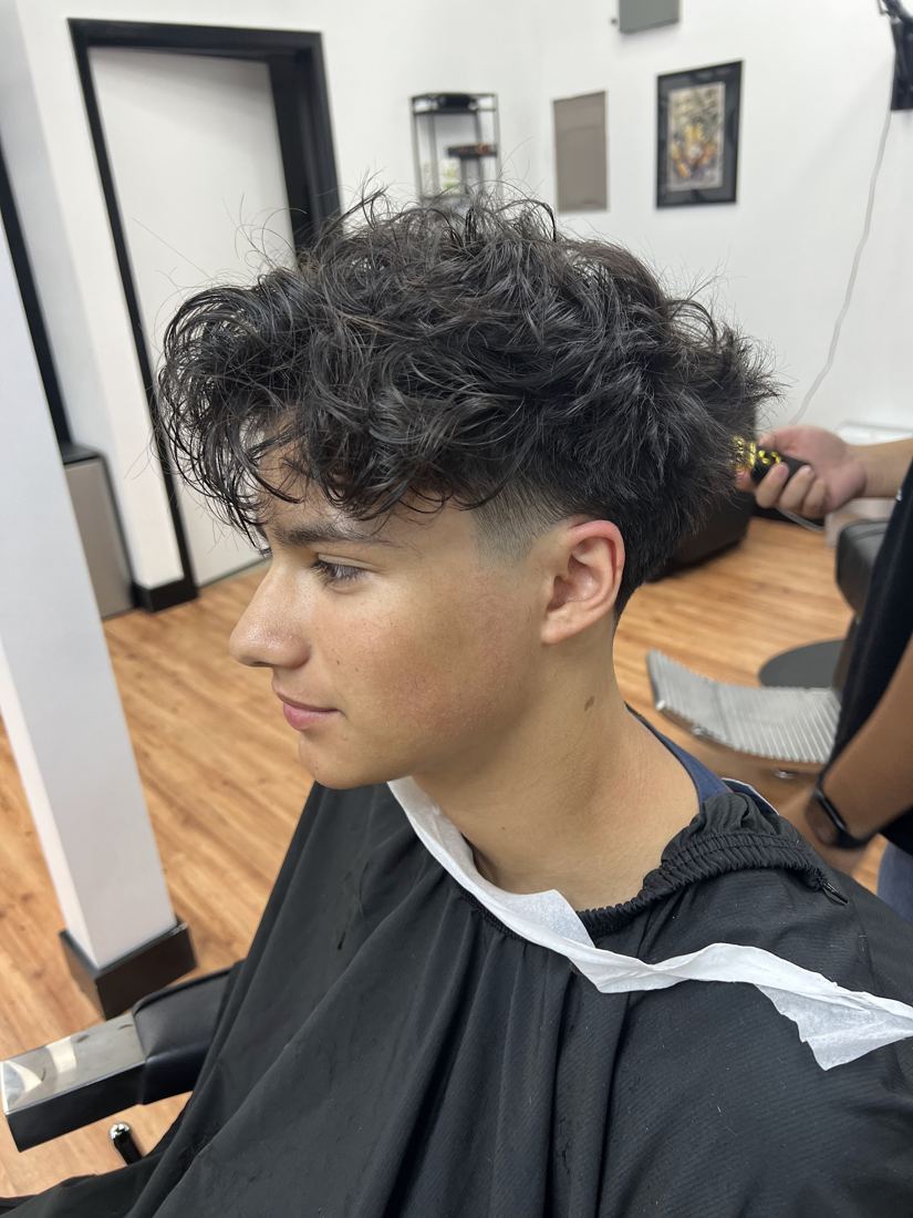 Textured curly cut with a clean taper