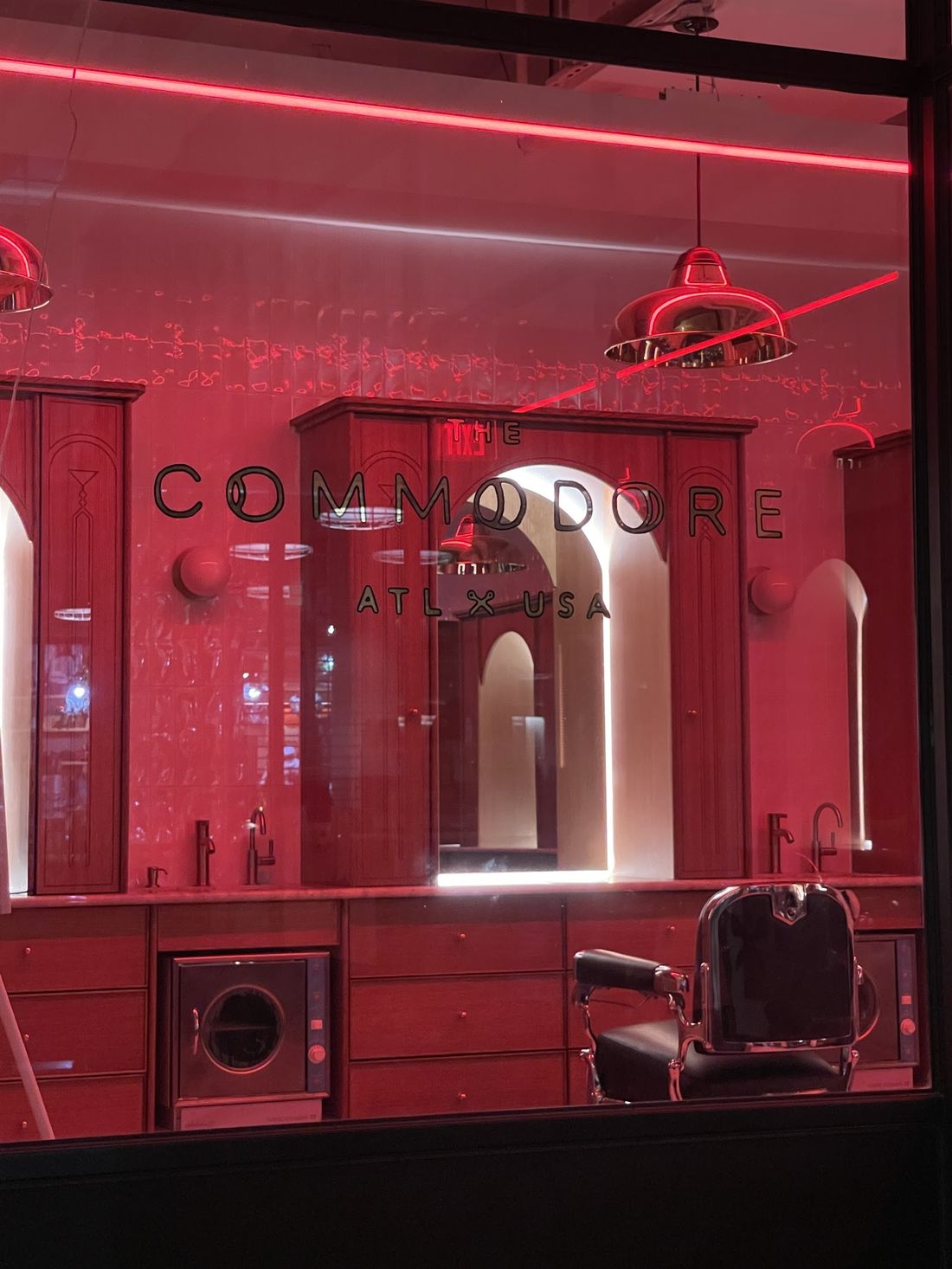 The Commodore neon glowing red in the Ponce City Market window