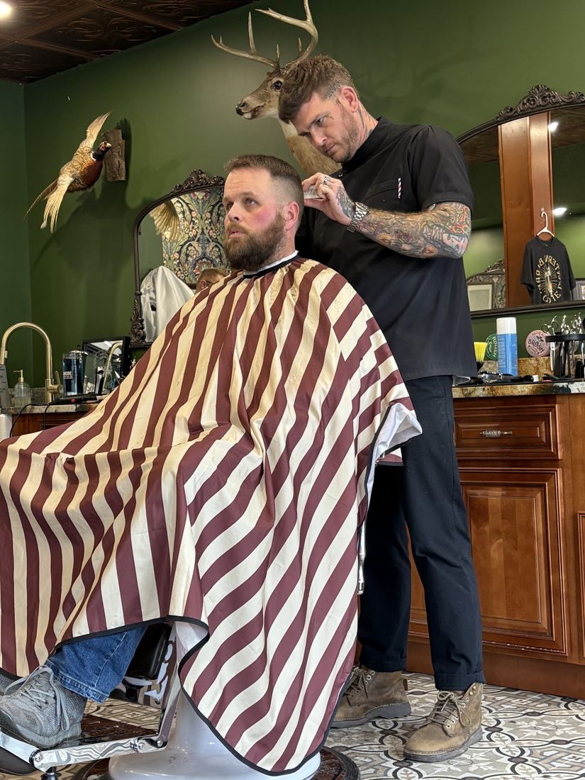 A haircut in the striped cape at the porcelain chair