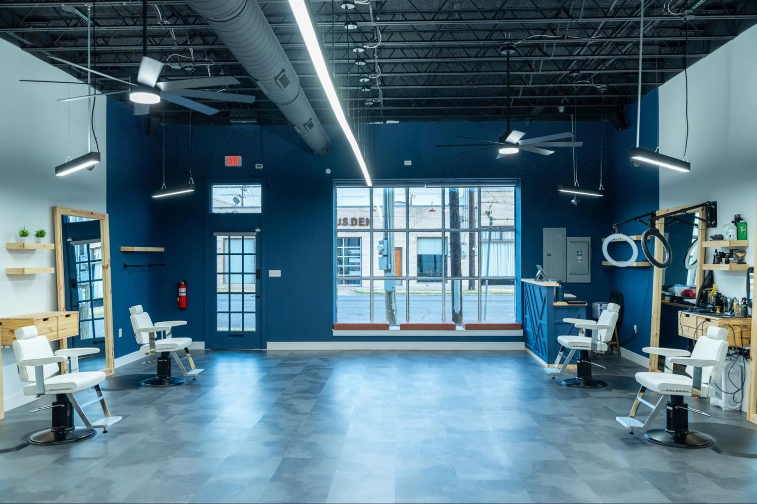 White chairs and navy walls inside The Players Club