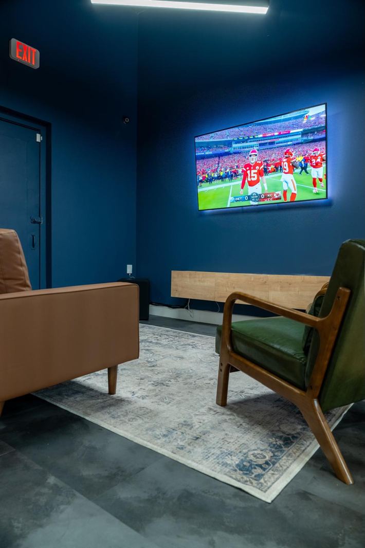 The lounge with the game on the TV