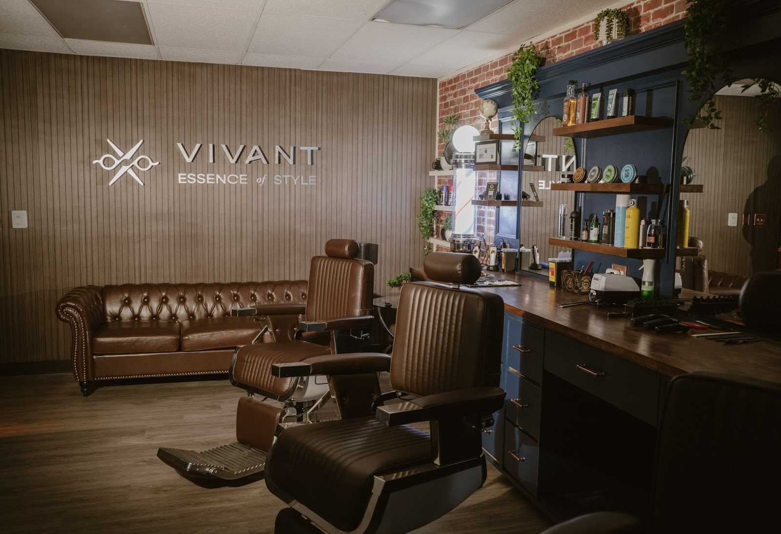 The Vivant logo wall and chesterfield couch inside the shop