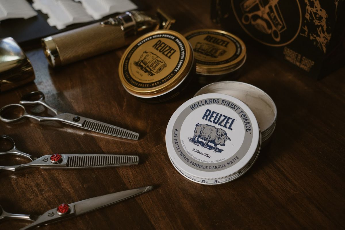 Reuzel pomades and shears on the bench