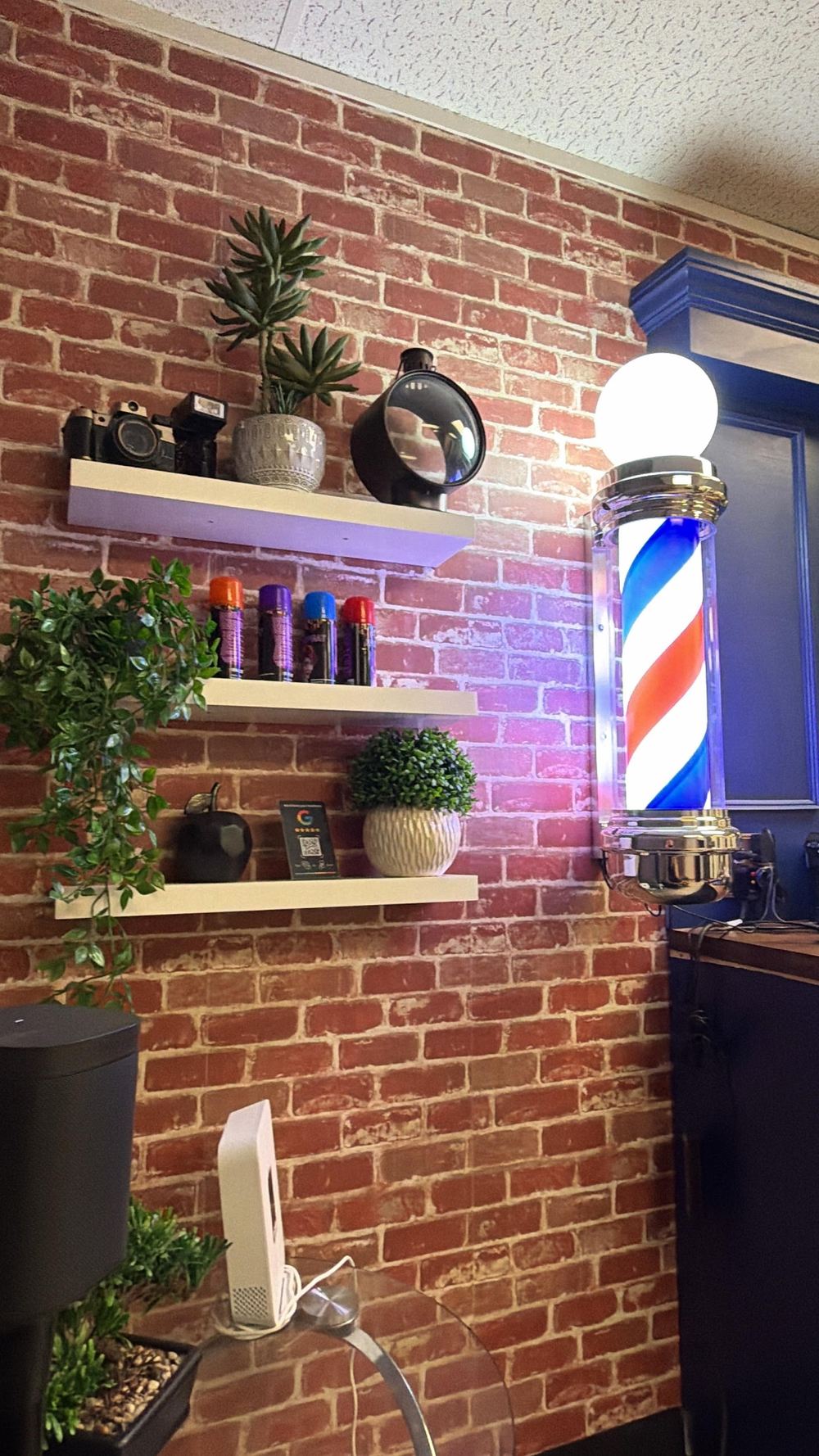 The barber pole on the brick wall