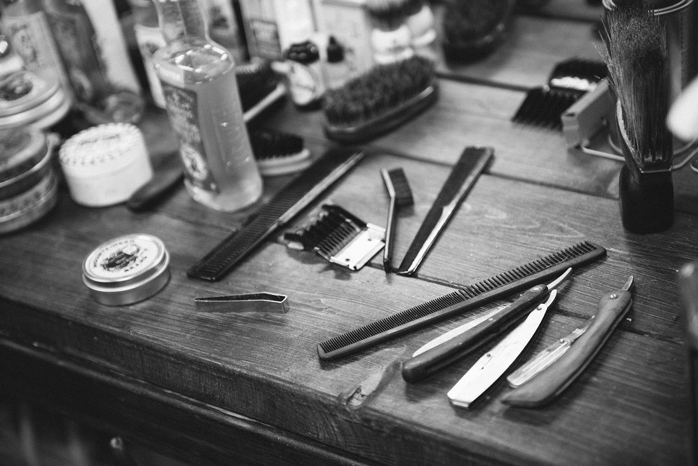 Straight razors, shears and brushes laid out at Wolf's